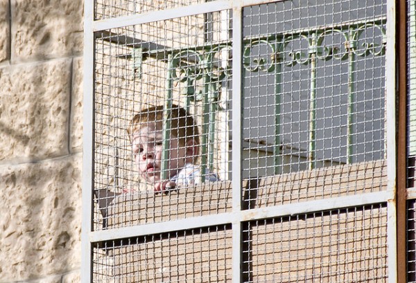 This picture of a child in the Palestinian city of Hebron is symbolic of the daily struggle the people of this region face.  In Hebrew, the word hebron means to "unite as friends"; in Arabic, it means "friend" or "Beloved of the Merciful".  This holy city is now deeply divided and full of hatred and intolerance.