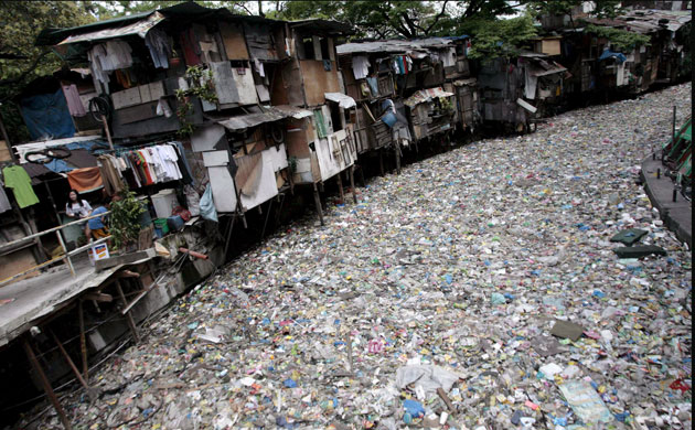 A creek polluted with trash in a Philipino slum
