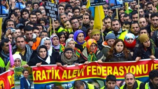 About 15,000 Kurds from all over Europe protest the death of 3 female Kurdish peace activists who were shot in the head in Paris.