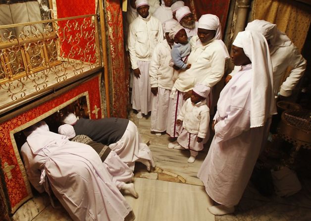 Christians from Nigeria gather in the Grotto of the Church of the Nativity to pray on Christmas Eve