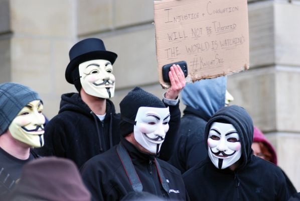 Members of the group Anonymous, wearing Guy Fawkes masks,are protesting that more people should be charged in the case of two high school football players charged with raping a 16-year-old girl in Steubenville, Ohio.