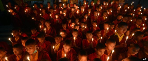 Buddhist Monks light candles in remembrance of an Indian woman who died after a gang rape on a moving bus.