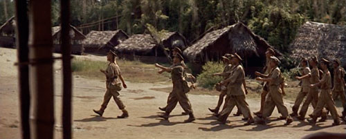 In the 1957 WWII film Bridge on the River Kwai, British prisoners of war are marched into a Japanese prison camp, led by Colonel Nicholson (played by actor Alec Guinness).  As a sign of strength, dignity and defiance, they enter the camp whistling the Colonel Bogey March.  See http://www.youtube.com/watch?v=83bmsluWHZctp://www.youtube.com/watch?v=83bmsluWHZc